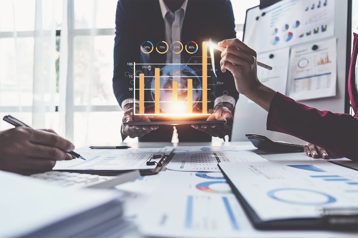 Our Services 1 Diverse team discussing financial charts and market research at office meeting.