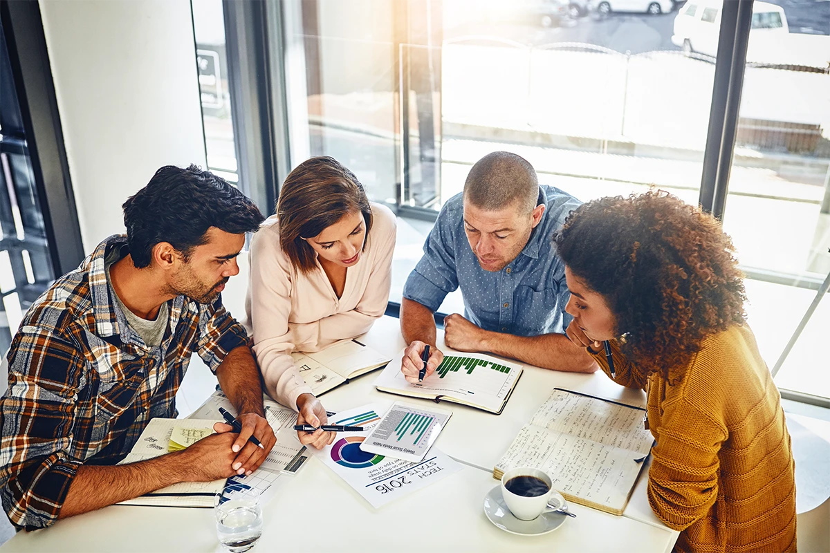 Usability Testing team analysing user feedback, performance reports, and design improvements during a collaborative strategy meeting.